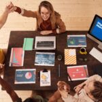 Home Colleagues celebrating success in a modern digital marketing office with teamwork and collaboration.