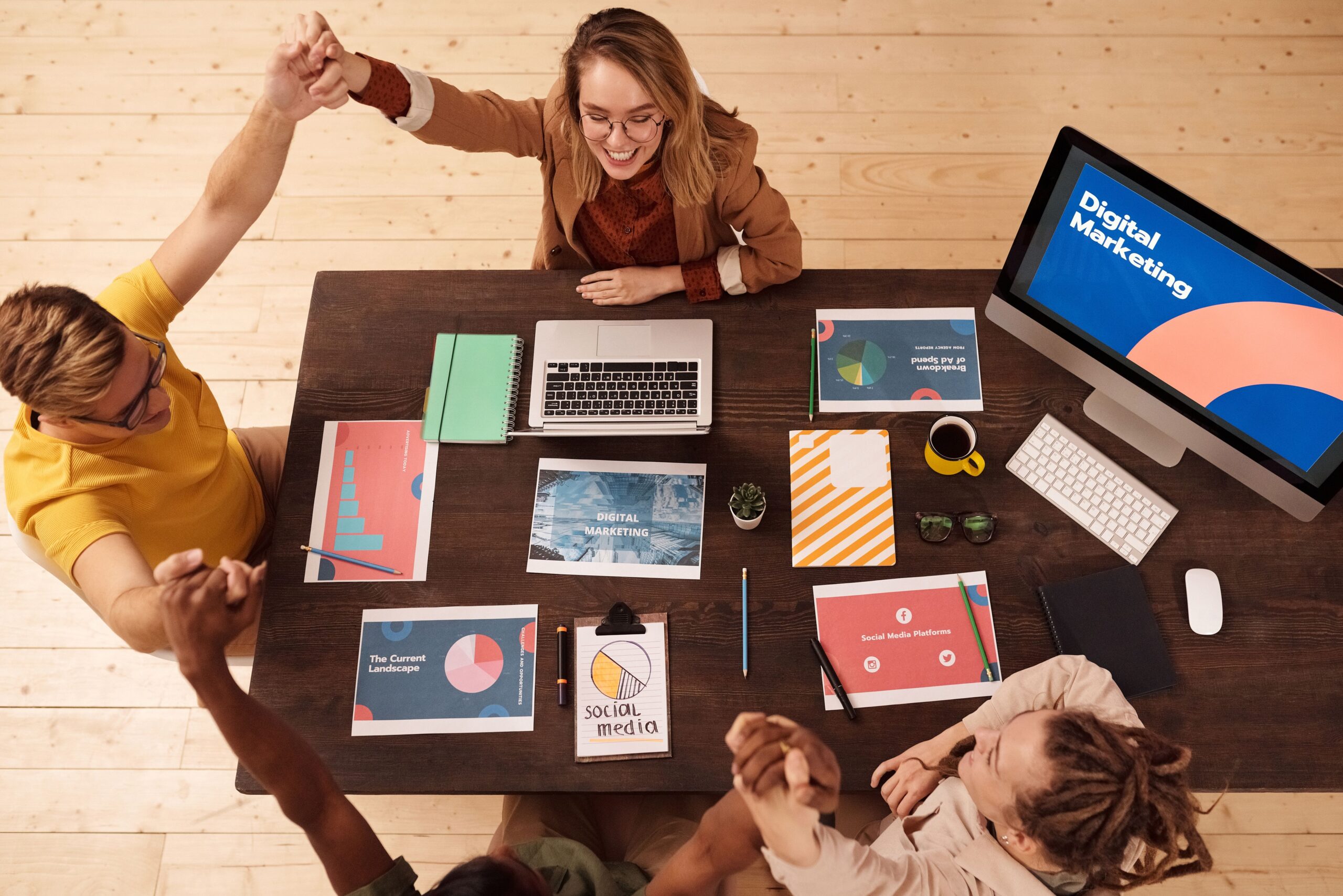Home Colleagues celebrating success in a modern digital marketing office with teamwork and collaboration.